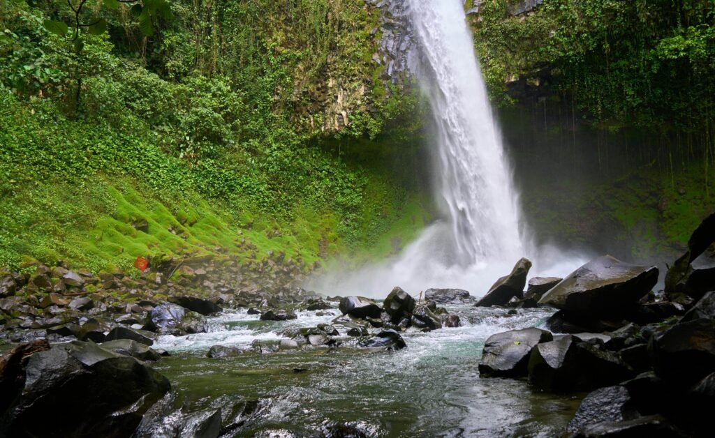 la fortuna waterfall base volcanic rocks moss scaled La Fortuna