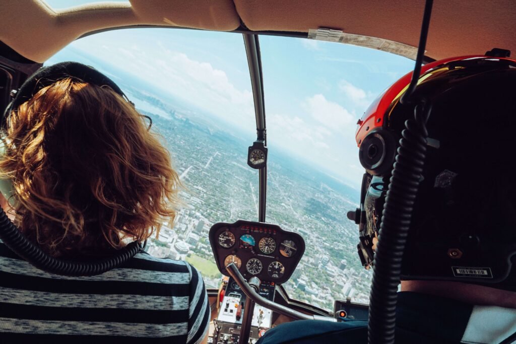 Passenger looking out over the cockpit and instrument panel during a scenic flight, similar to a Costa Rica helicopter tour
